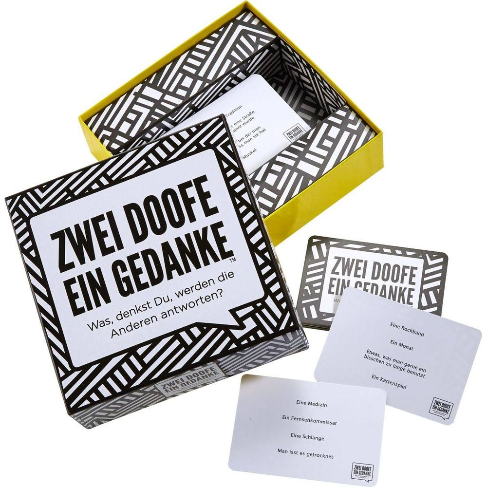Il gioco 'Zwei Doofe Ein Gedanke' con carte di gioco aperte e una scatola.