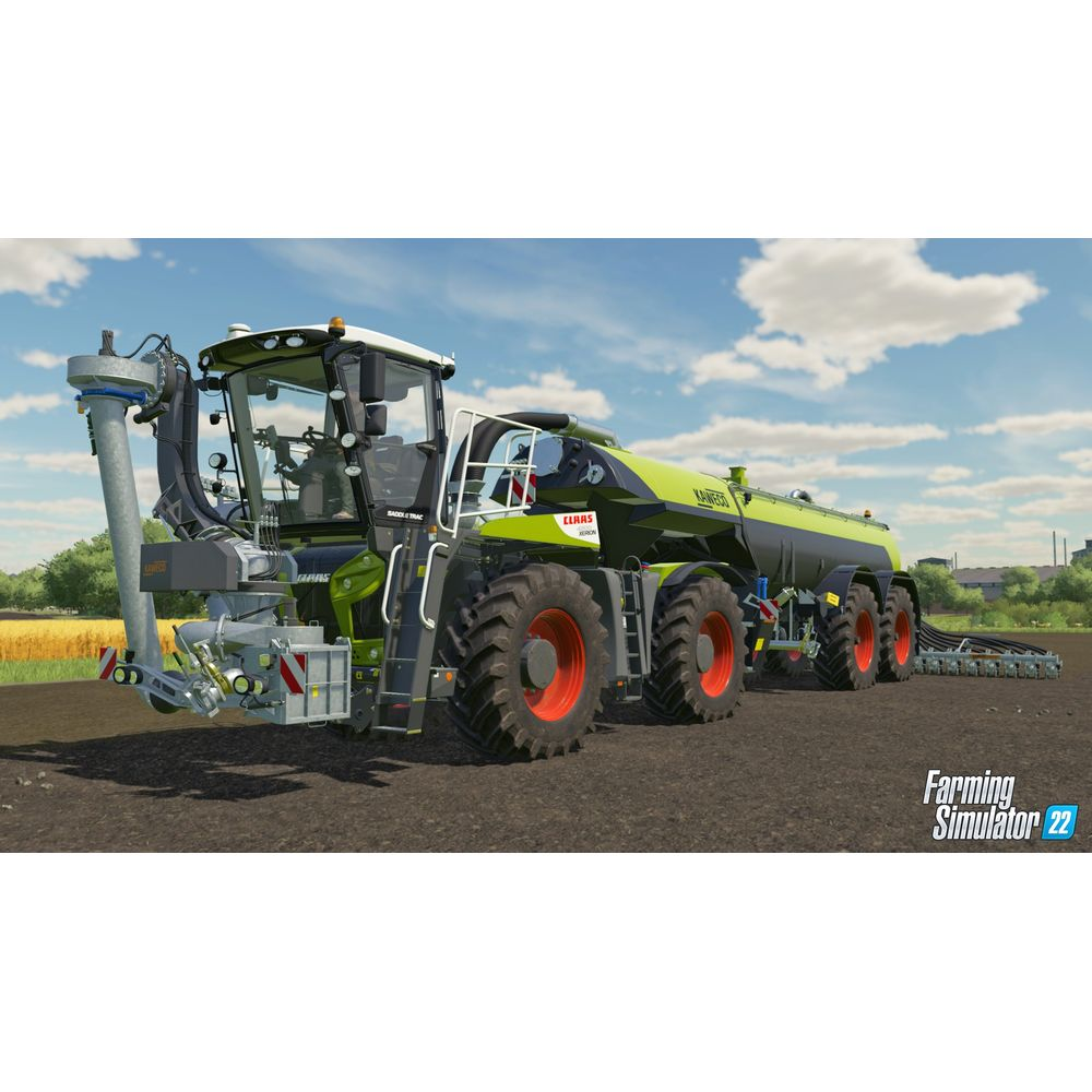 Grüner und schwarzer Gülle-Anhänger mit großer Bereifung auf einem Feld.