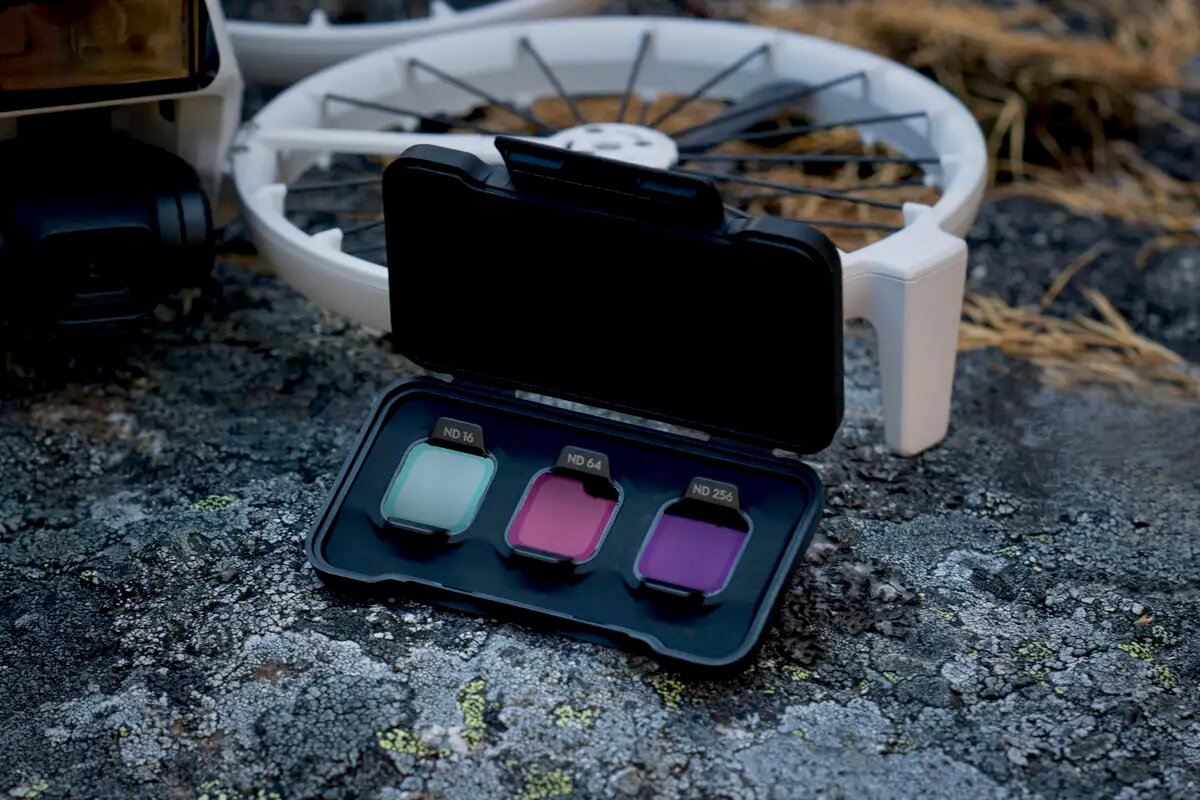 Un kit de filtros para drones con filtros ND16, ND64, ND256 abierto sobre rocas.