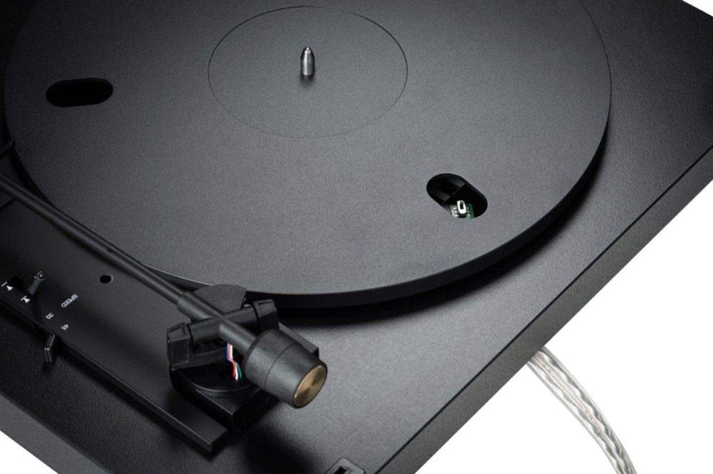 Black turntable with tonearm and needle.