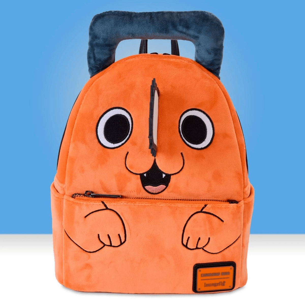 Una mochila naranja de felpa con cara de perro de dibujos animados, ojos grandes y boca abierta.