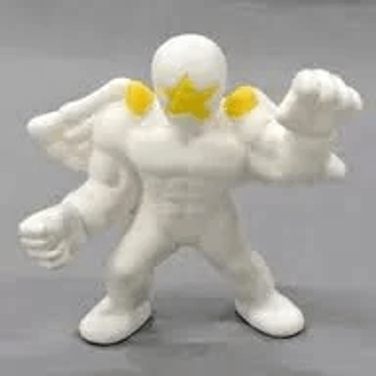 Una figura de acción blanca con una estrella amarilla en la cara y detalles amarillos en los hombros.