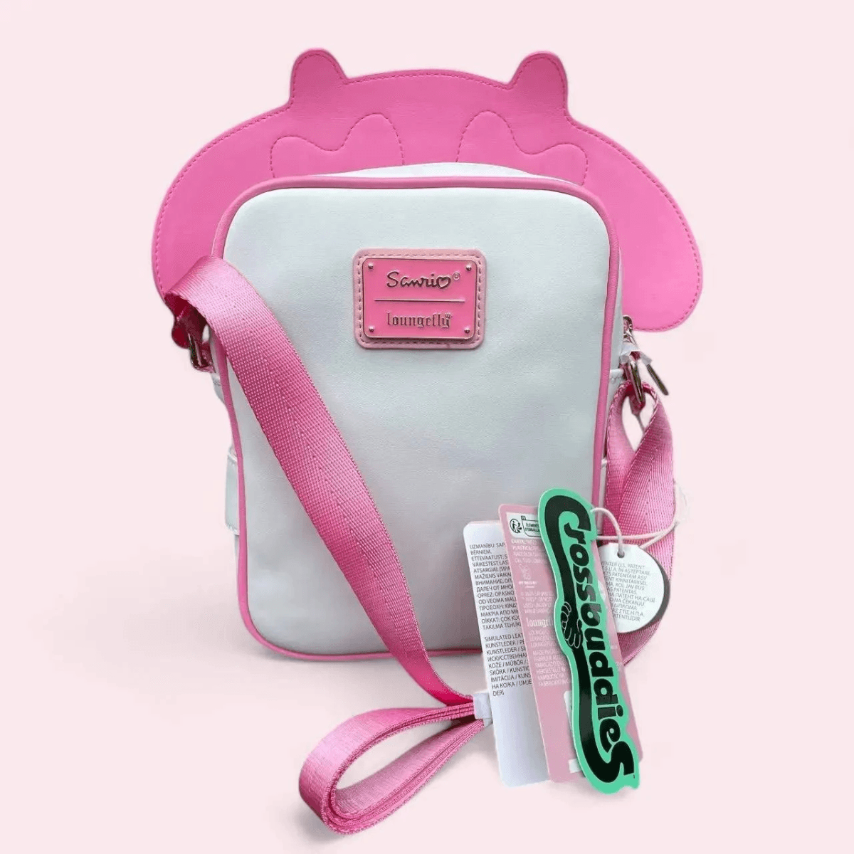 Bolso blanco con aplicación de orejas de gato rosas y correa rosa. Logo Sanrio.