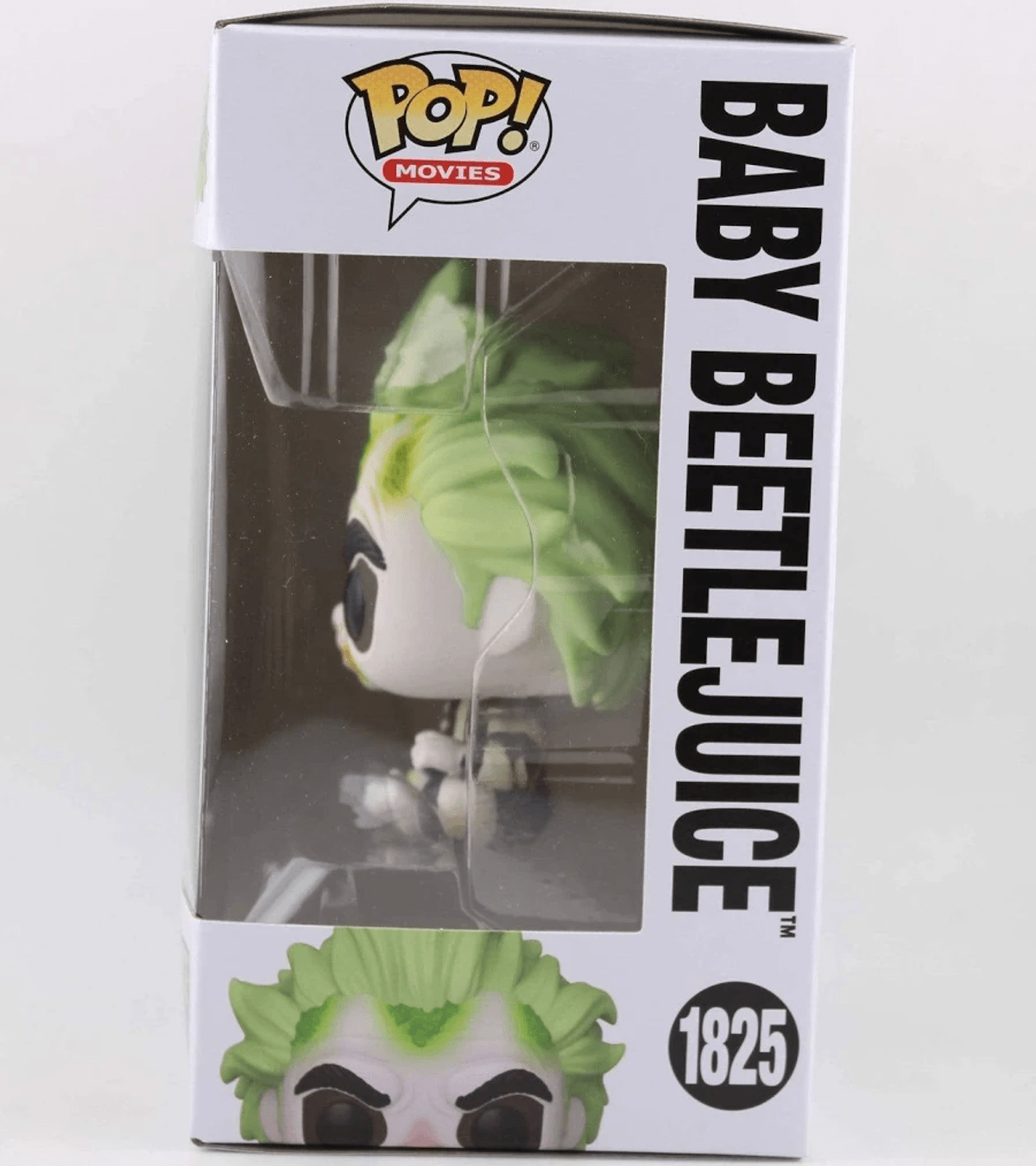 Figura Funko Pop! Baby Beetlejuice en caja, con pelo verde y cara blanca.
