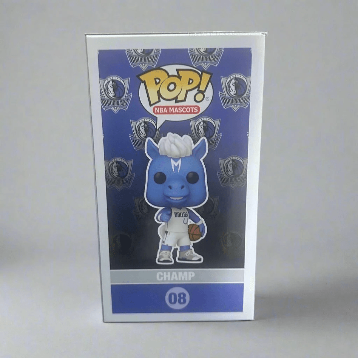 Blauer Funko Pop! NBA Maskottchen "Champ" mit Basketball und Dallas Mavericks Logo.