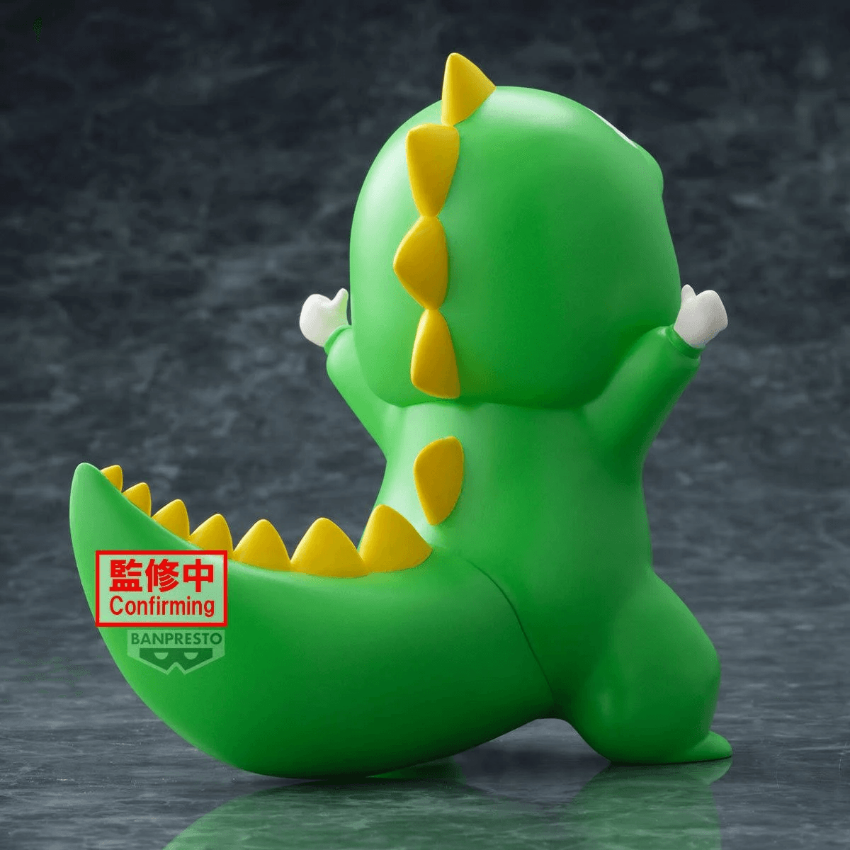 Personaggio dinosauro verde con spuntoni gialli su schiena e coda.