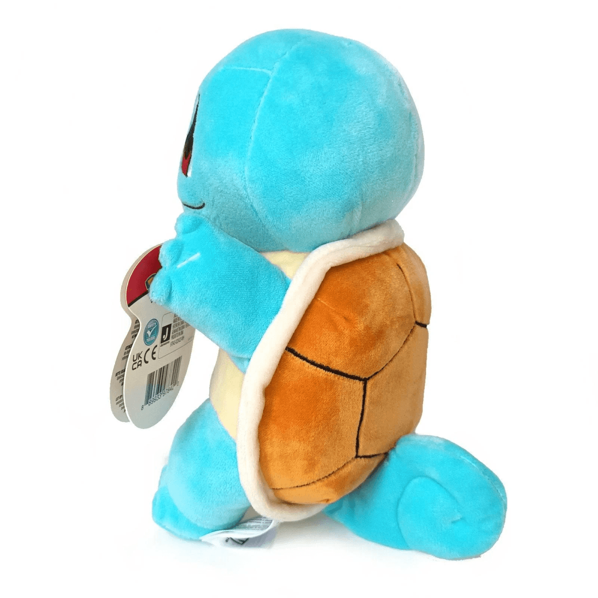 Un peluche azul de Squirtle, un Pokémon, se arrodilla con un caparazón en la espalda.