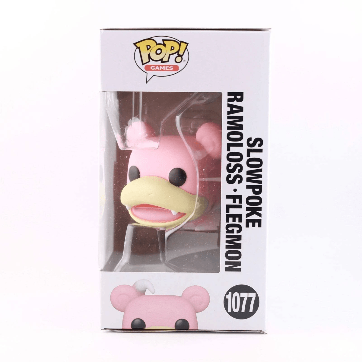 Figura Funko Pop! rosa de Slowpoke en su caja. La figura tiene un pico amarillo.