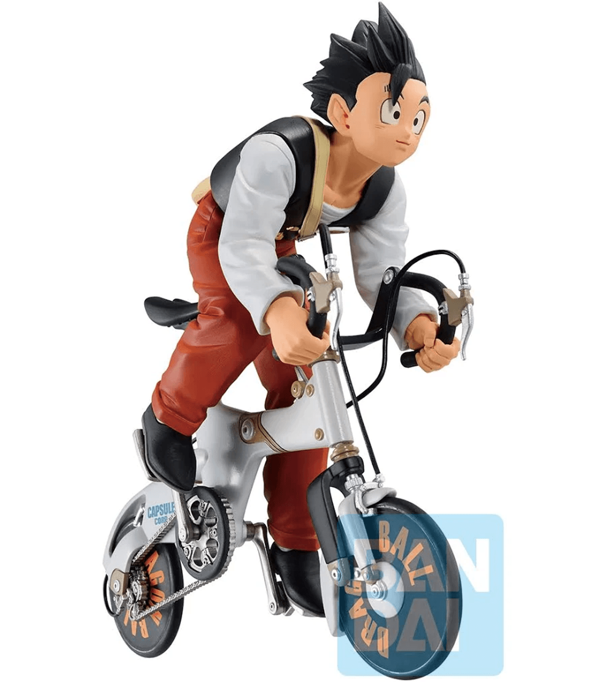 Figura de anime de un niño con pantalones naranjas y camisa blanca montando una bici.