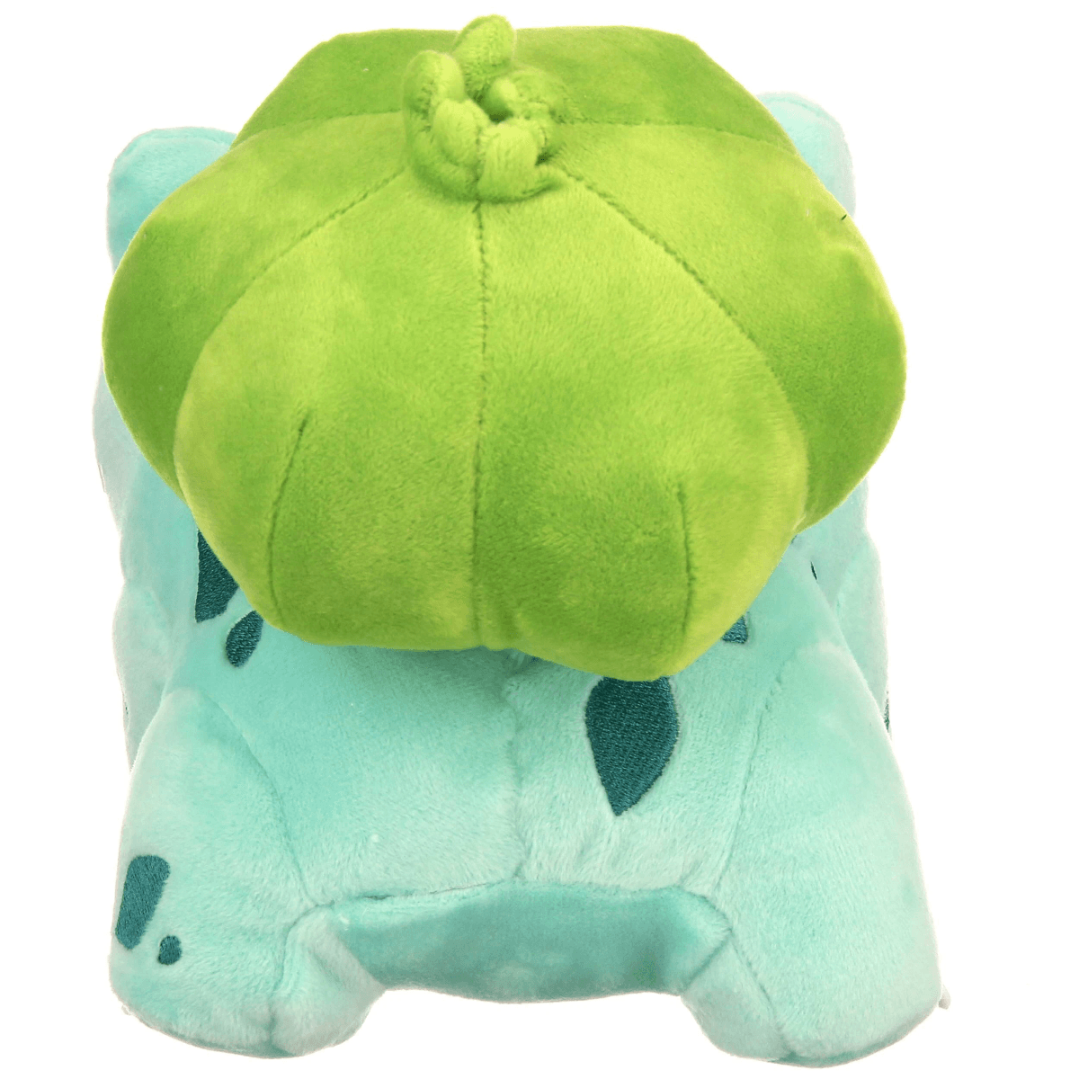 Un juguete de peluche azul claro de una criatura con un gran bulbo verde en su lomo.