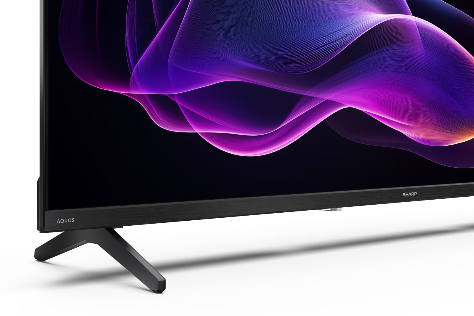 Una TV moderna con un motivo astratto a onde viola sullo schermo e un supporto nero.