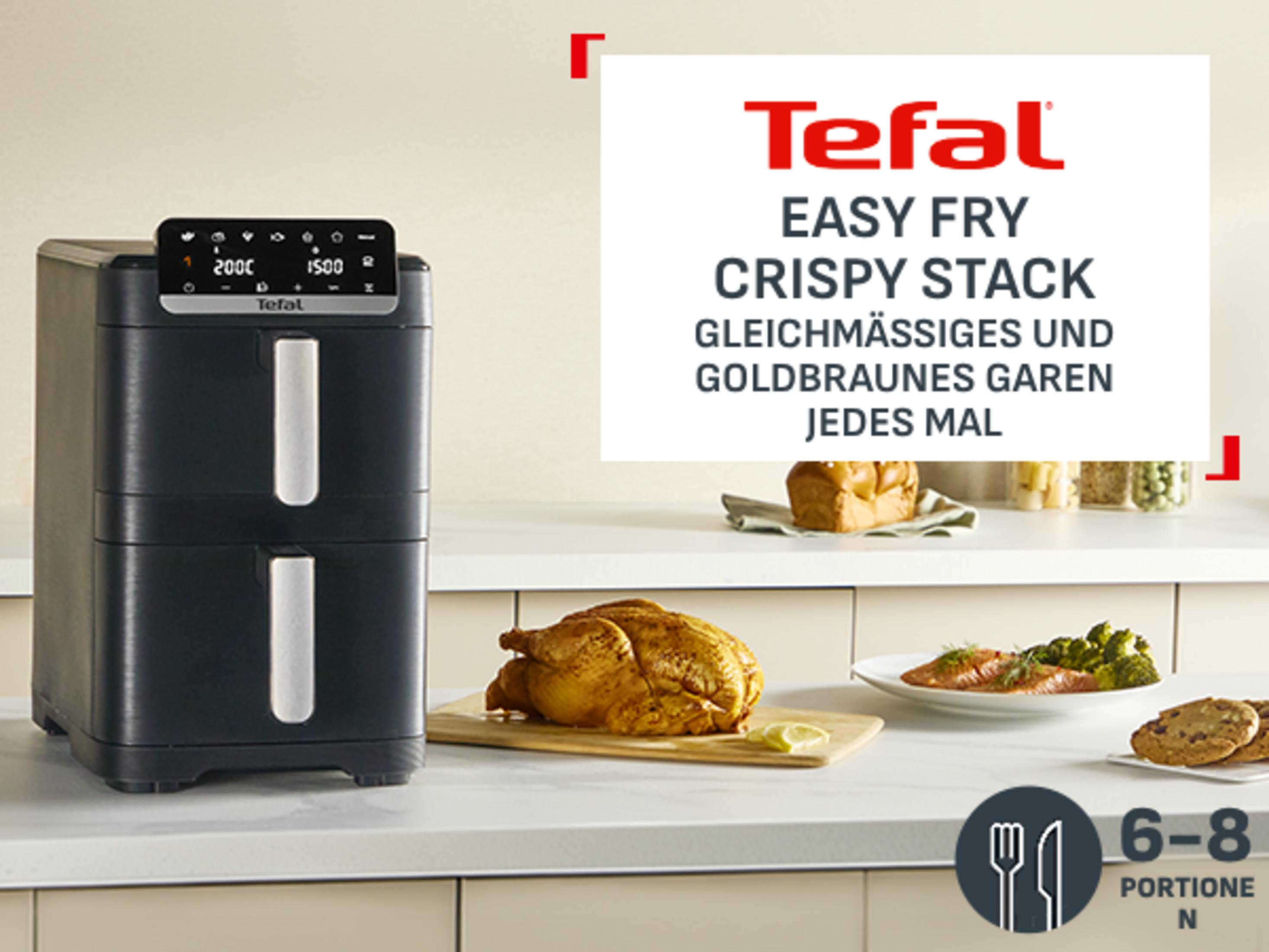 Una friggitrice ad aria Tefal con pollo arrosto e contorni.