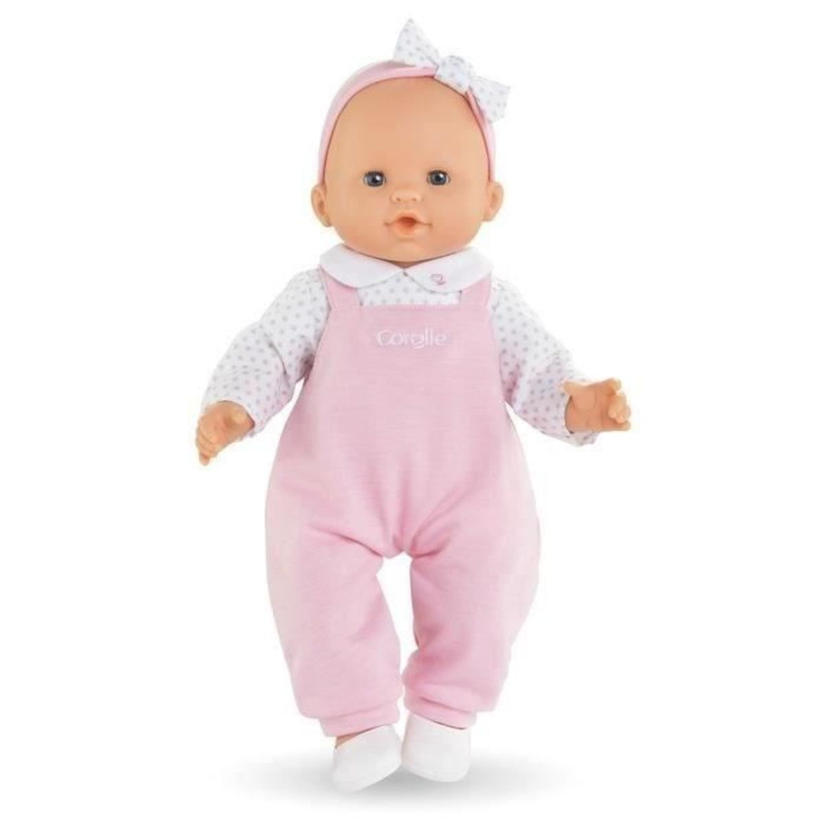 Eine Puppe mit rosafarbener Latzhose und gepunktetem Oberteil.