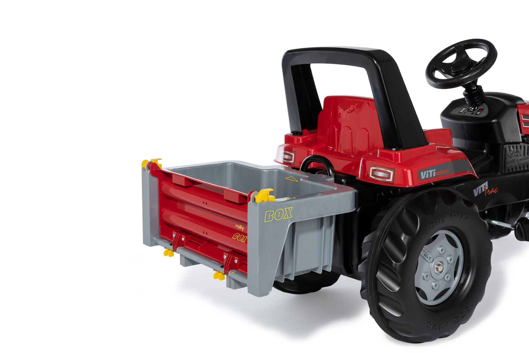 Roter Spielzeugtraktor mit angehängtem grauem Anhänger. Mit schwarzem Lenkrad und Überrollbügel.