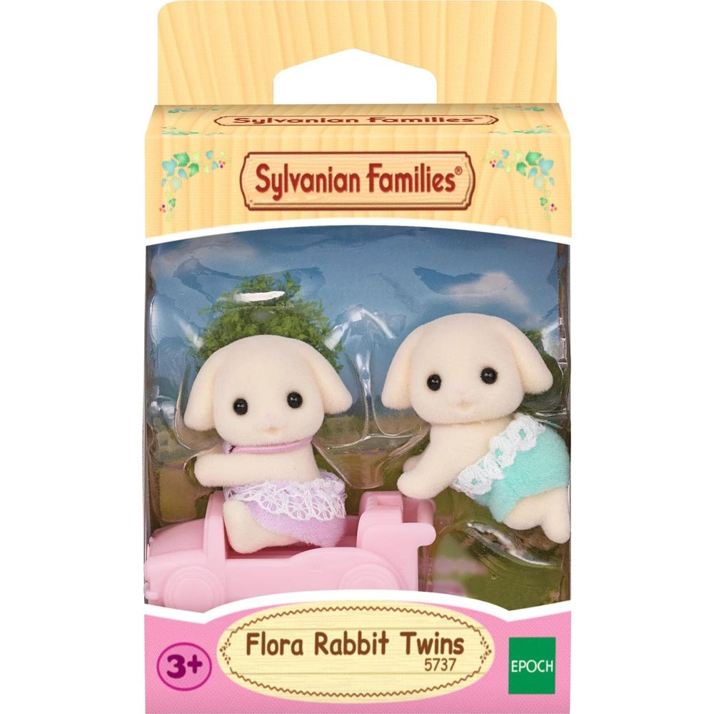 Dos conejitos gemelos Sylvanian Families blancos en un embalaje de coche de juguete rosa.