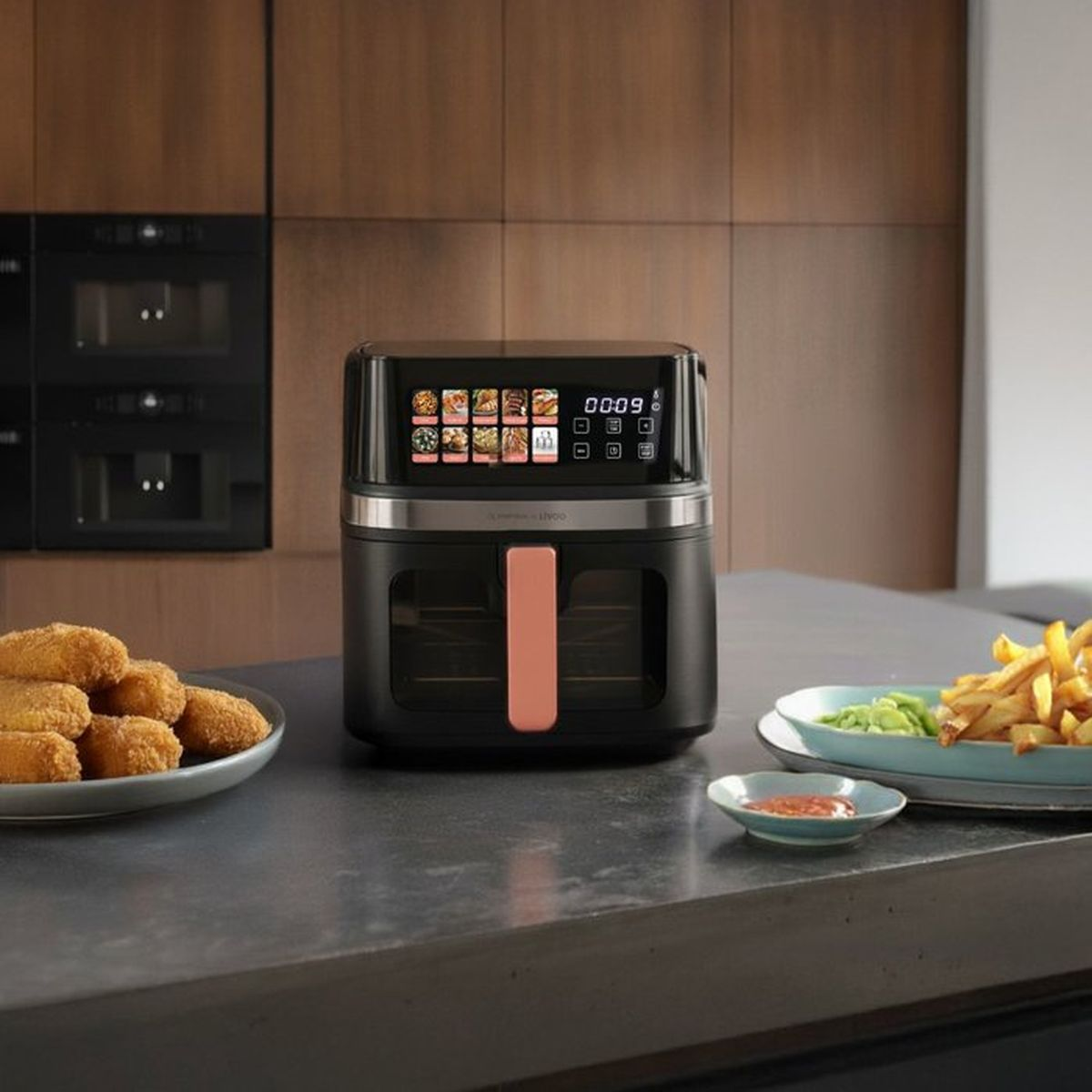Una friggitrice ad aria nera è su un bancone con crocchette di pollo e patatine fritte.