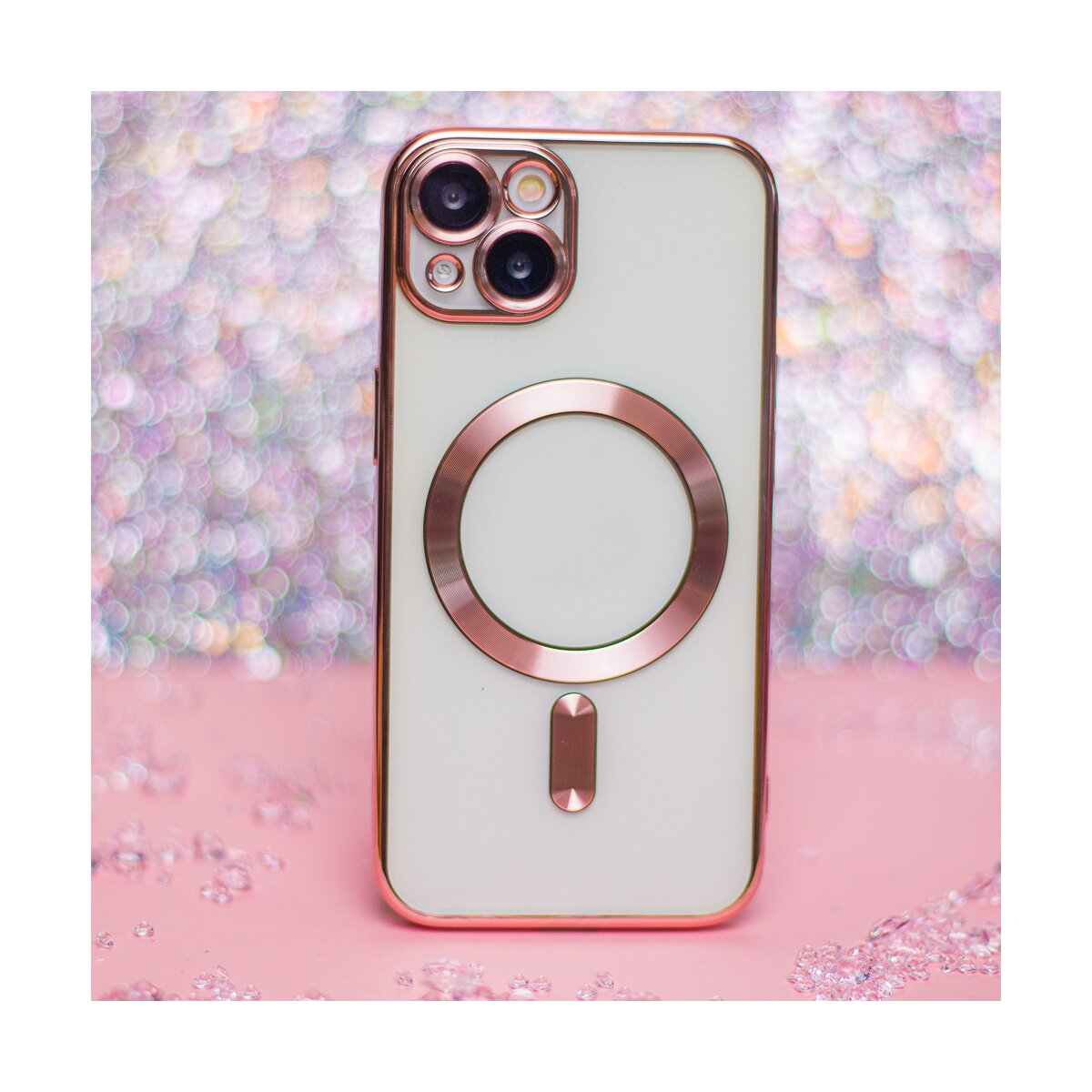 Ein weißes Handy mit roségoldenem Rahmen auf rosa Untergrund mit Glitzer.