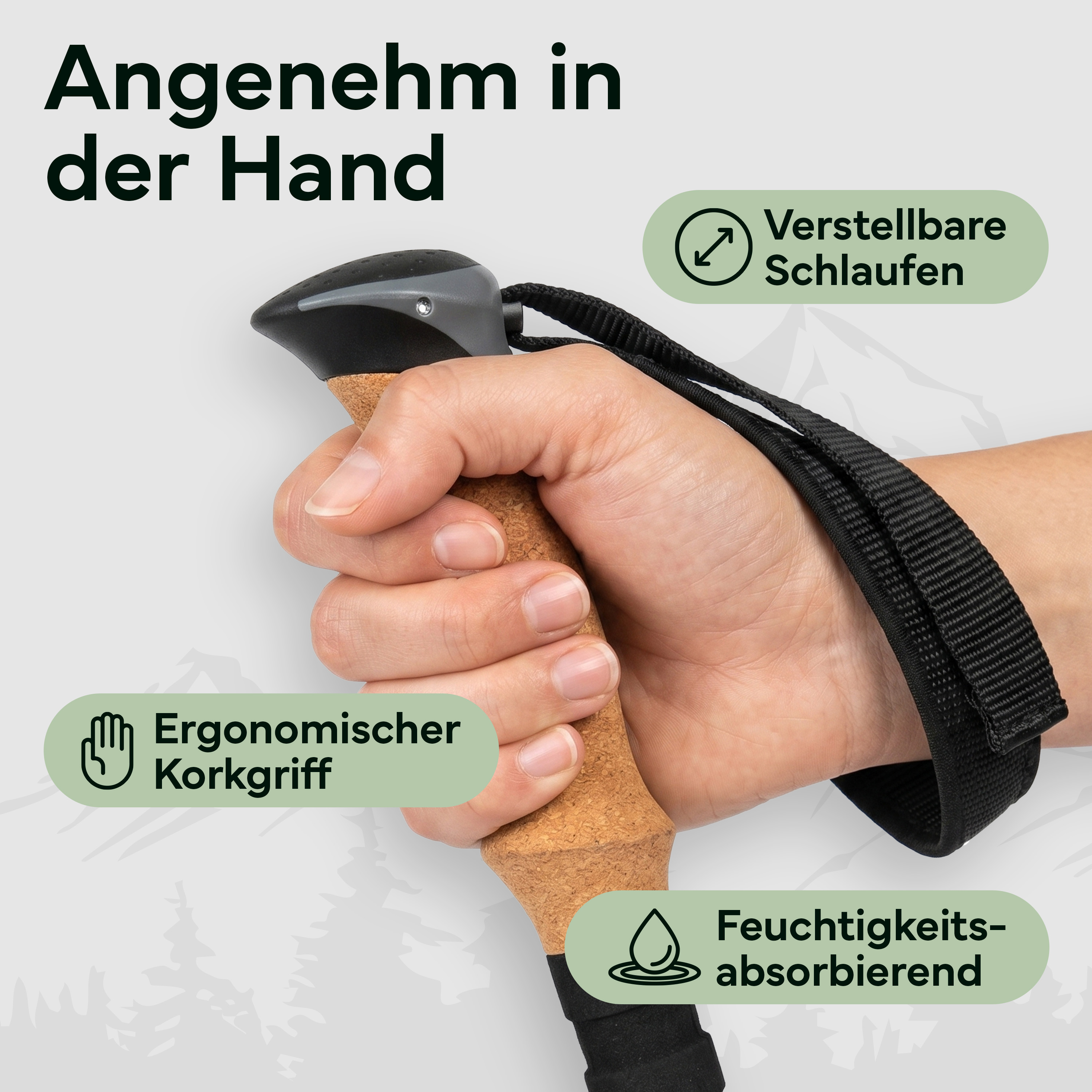 Hand hält Wanderstock mit Korkgriff, verstellbarer Schlaufe und Feuchtigkeitsabsorption.