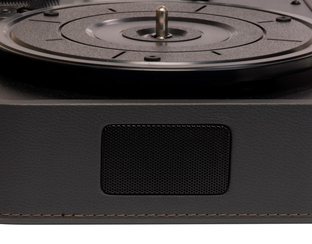 A close-up view of a black record player turntable and speaker grille.