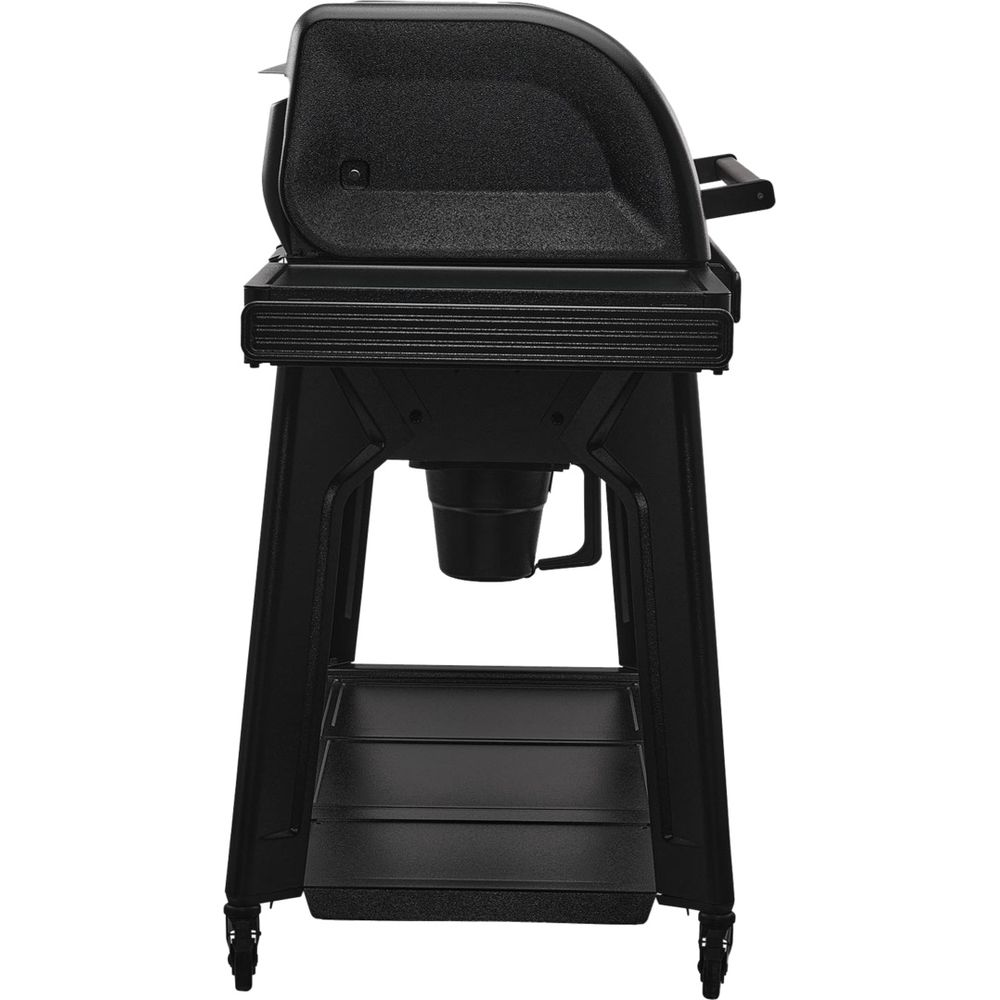 Un couvercle de grill noir sur un support noir avec étagère.