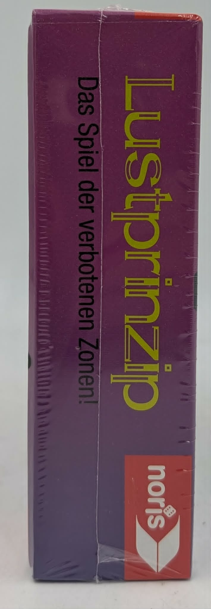Lustprinzip Spiel der verbotenen Zonen von Noris auf lila Verpackung.