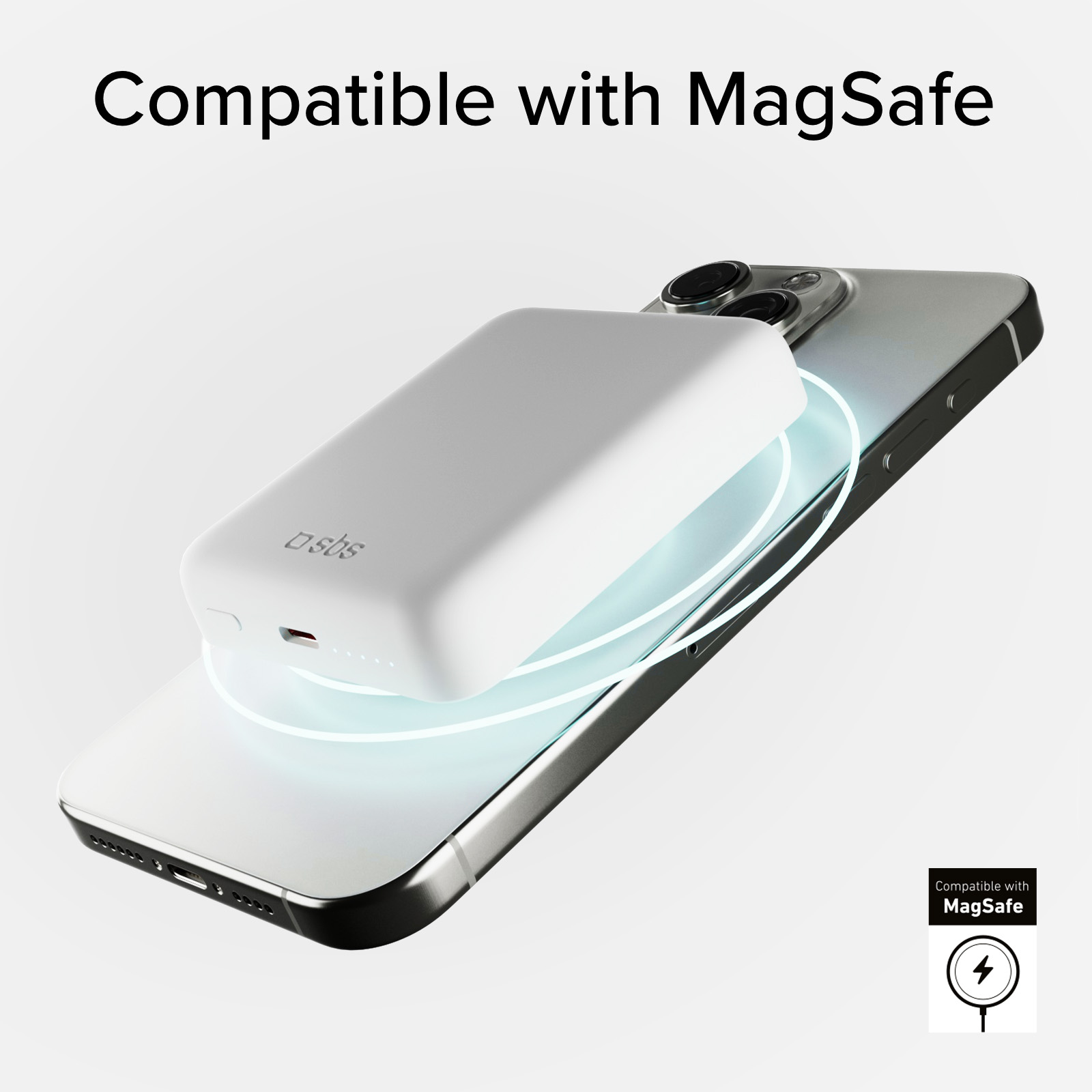 Un caricabatterie MagSafe bianco è posizionato su uno smartphone argentato.