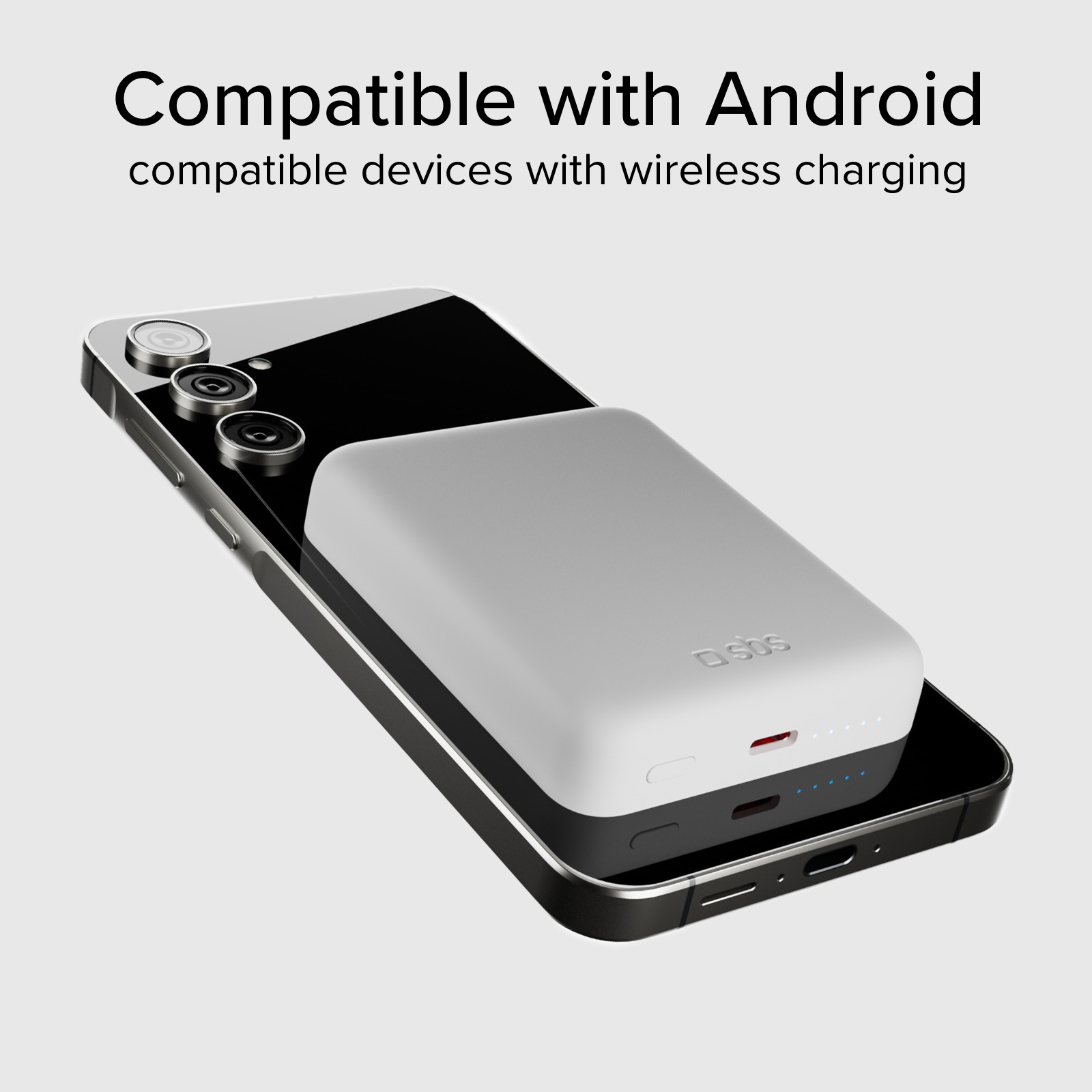 Un caricatore wireless bianco poggia su uno smartphone nero.