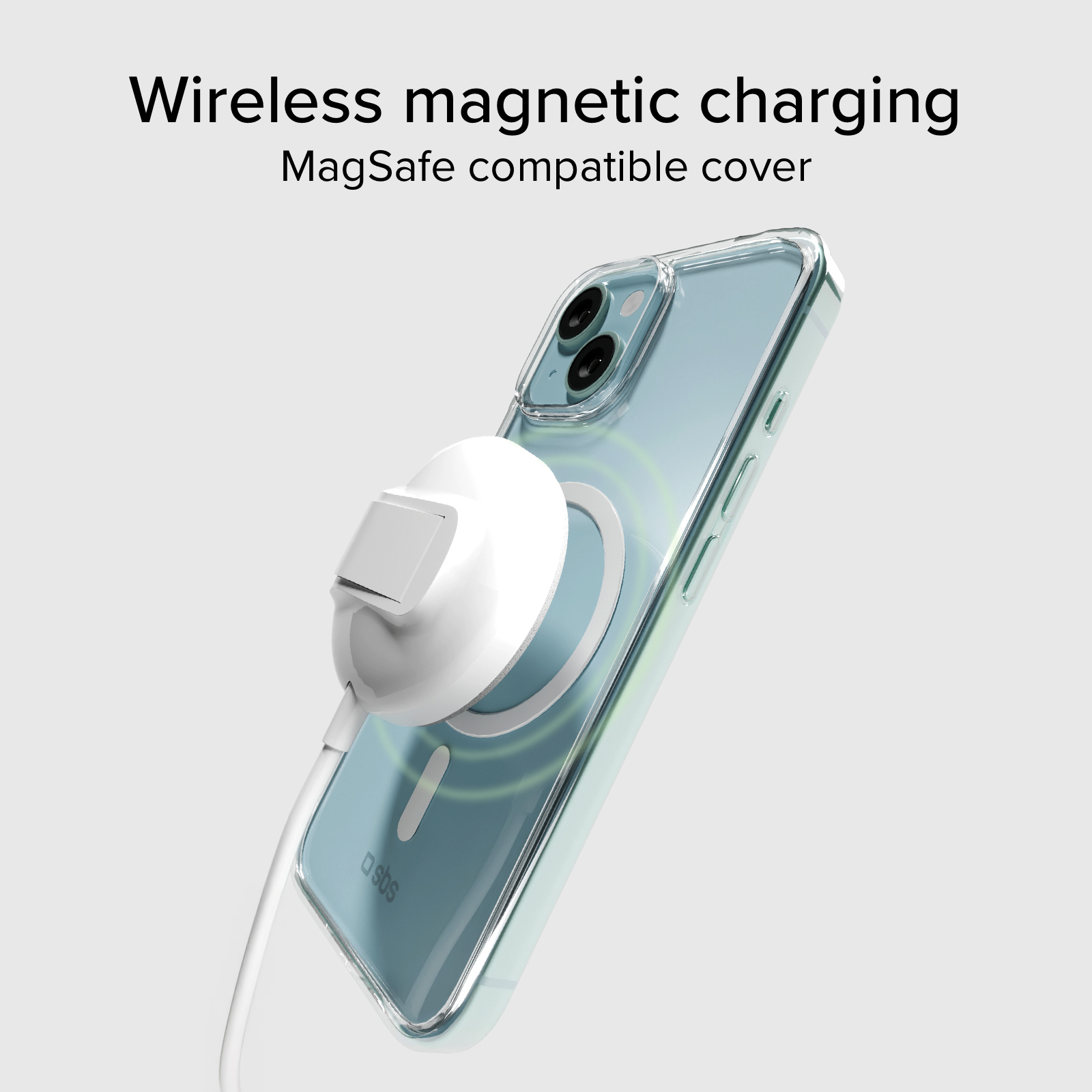 Un iPhone trasparente con caricabatterie MagSafe è su una superficie grigio chiaro.