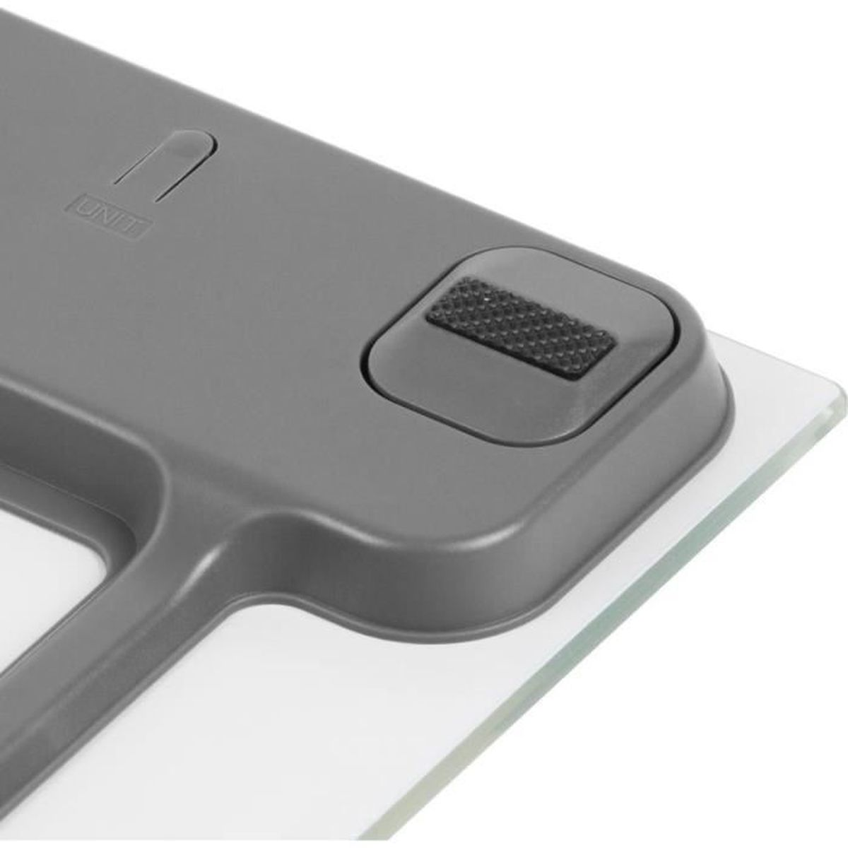 Graue Waage mit einem Knopf und einer "UNIT"-Beschriftung auf Glasbasis.