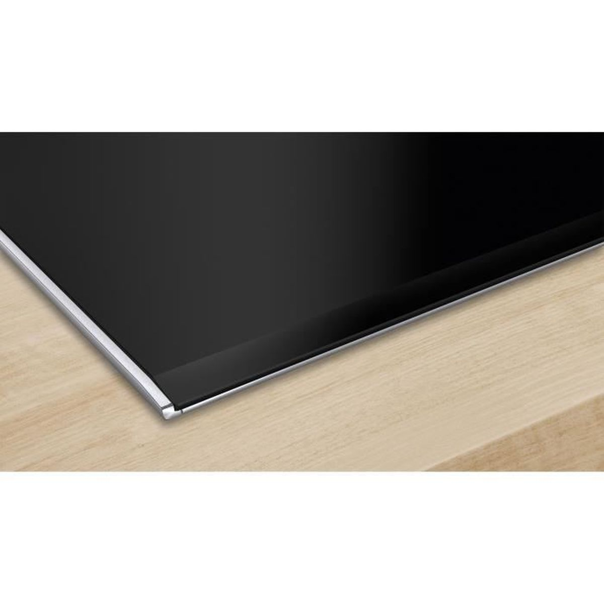 Close-up of a black cooktop with a silver trim on wood.