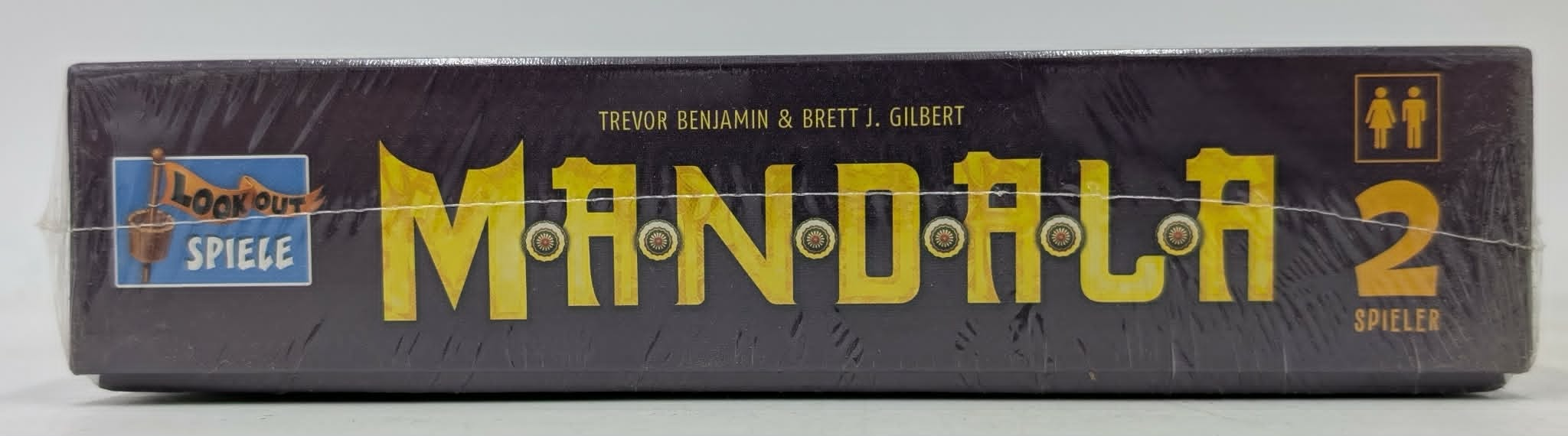 Schwarze Brettspielbox mit gelbem Mandala 2 Schriftzug und dem Logo von Lookout Spiele.