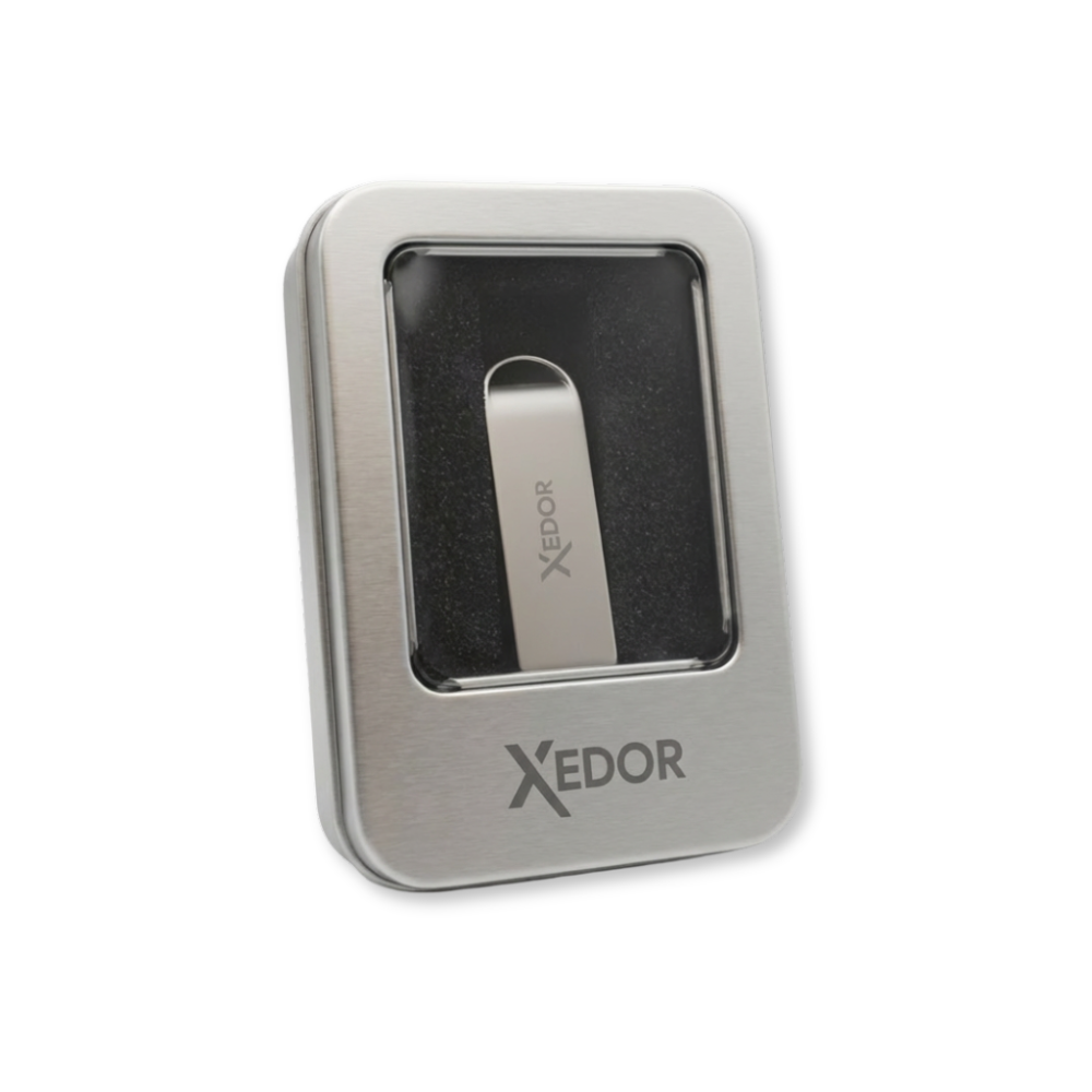 A silver USB drive with XEDOR logo inside a silver metal case.