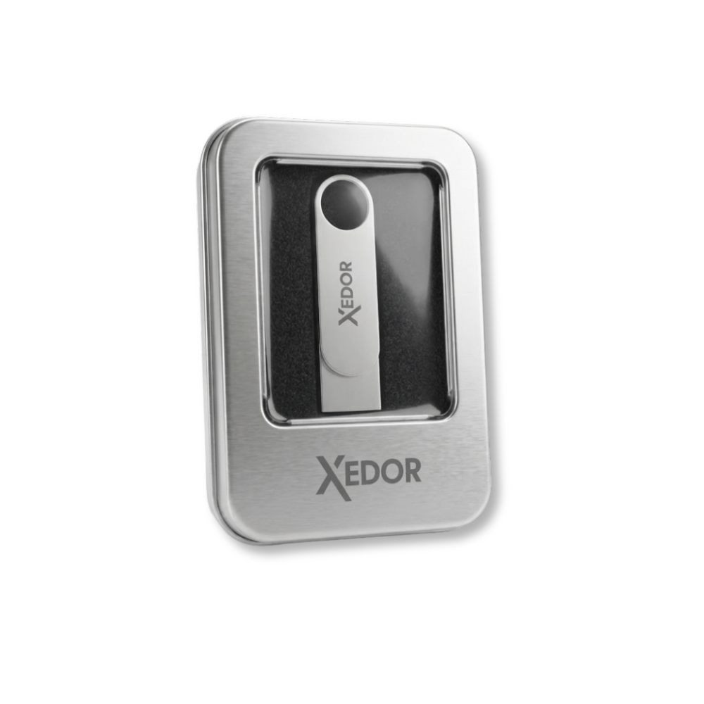 Silver USB drive with Xedor logo inside a silver gift box.