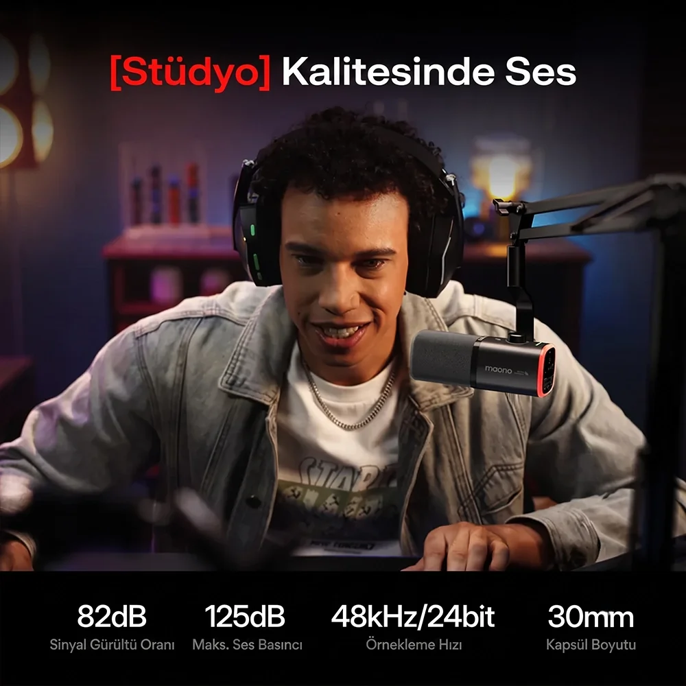 Man wearing headphones and a microphone, looking at a screen.