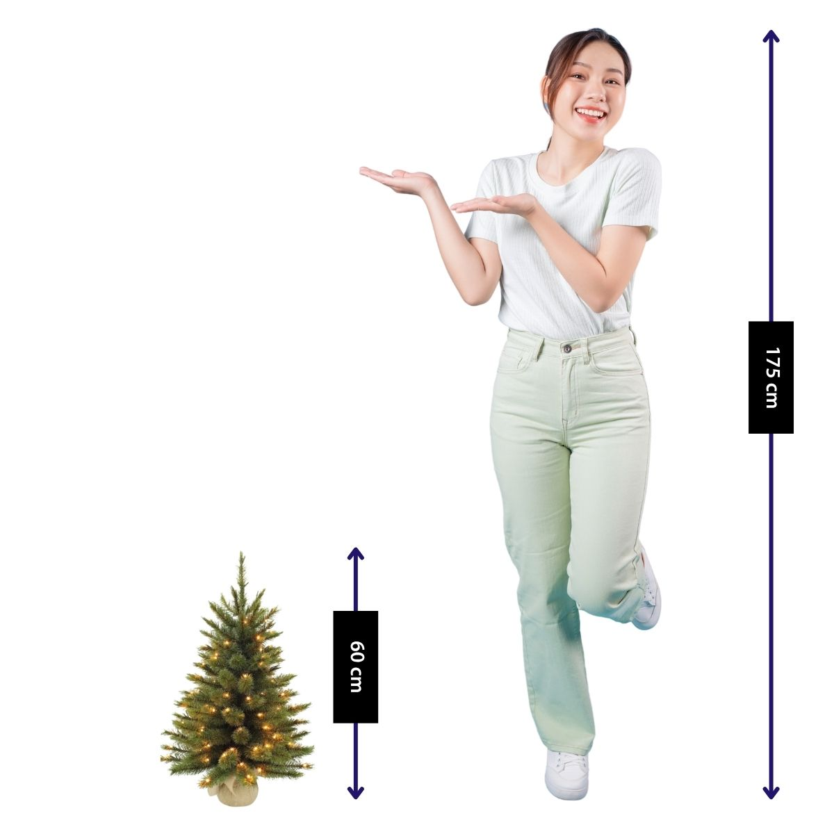 A woman stands next to a small Christmas tree with lights. Tree height: 60cm. Woman height: 175cm.