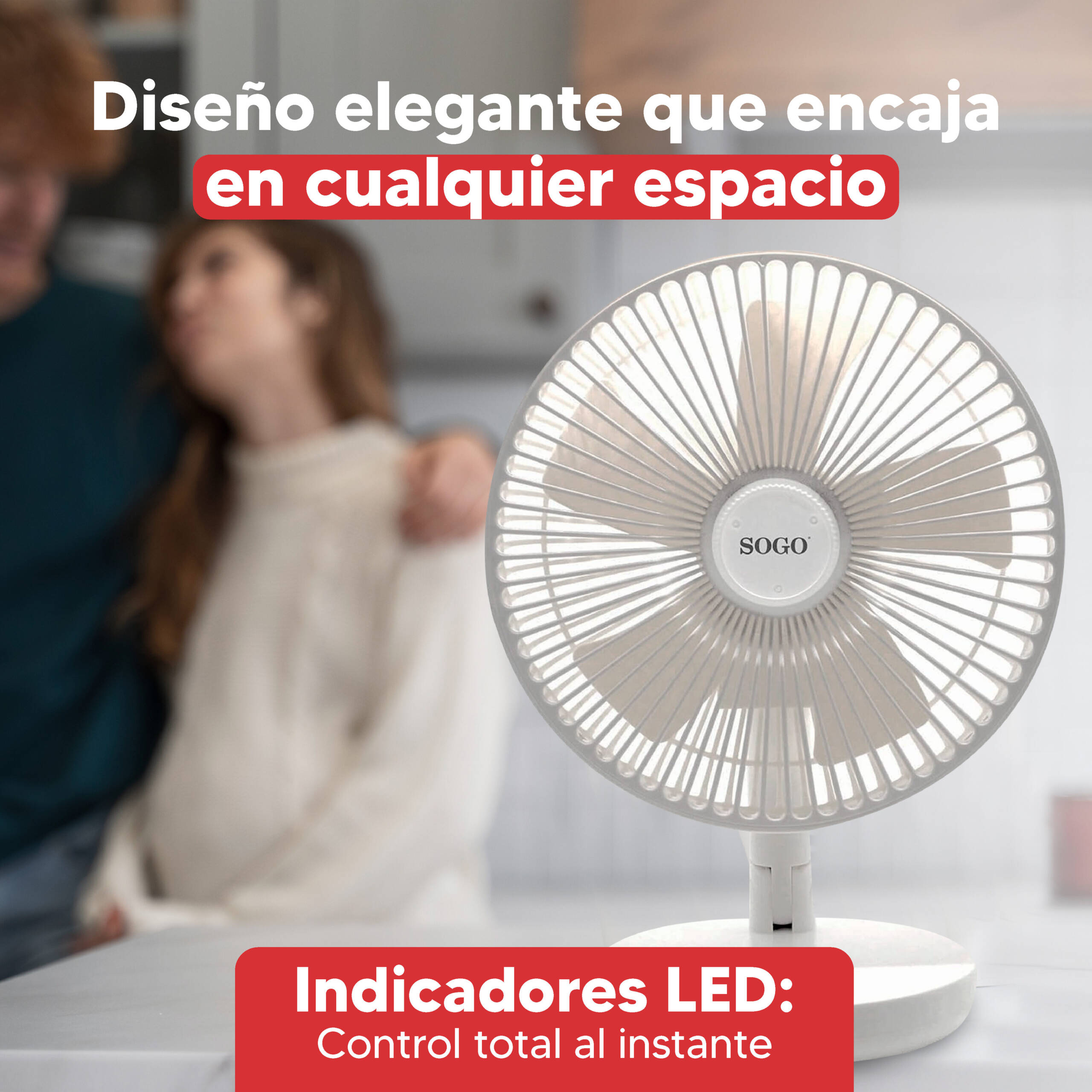 Un ventilatore bianco su un tavolo. Due persone sfocate sullo sfondo.