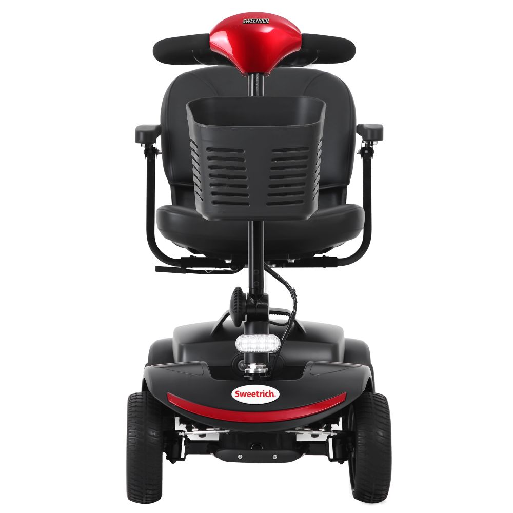 Uno scooter per la mobilità nero e rosso con cestino anteriore e braccioli.