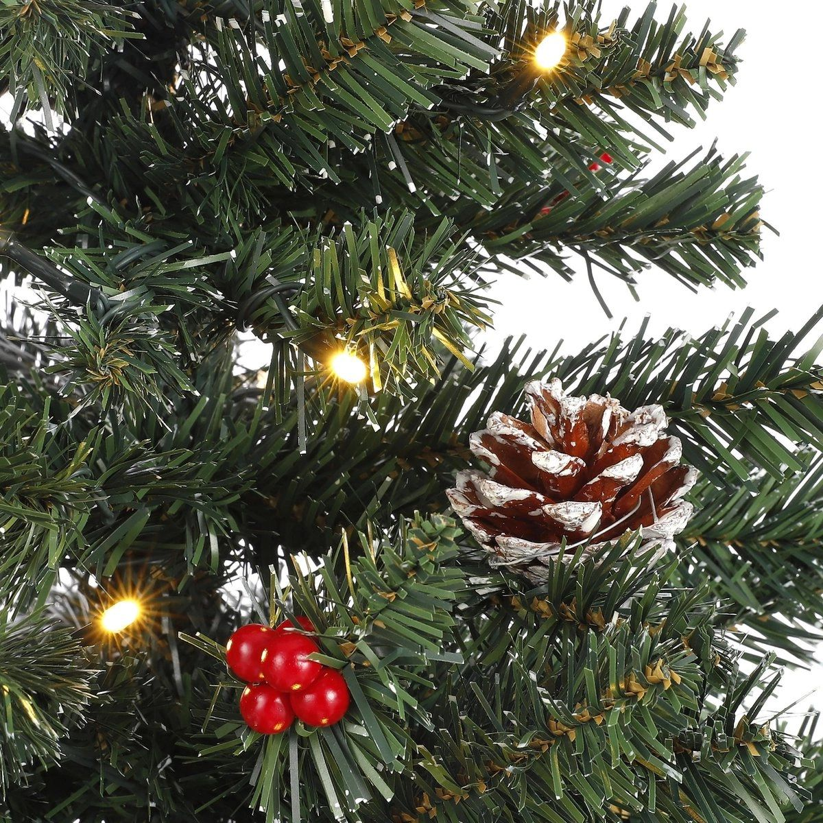 Artificial Christmas tree with a pinecone, red berries and lights.