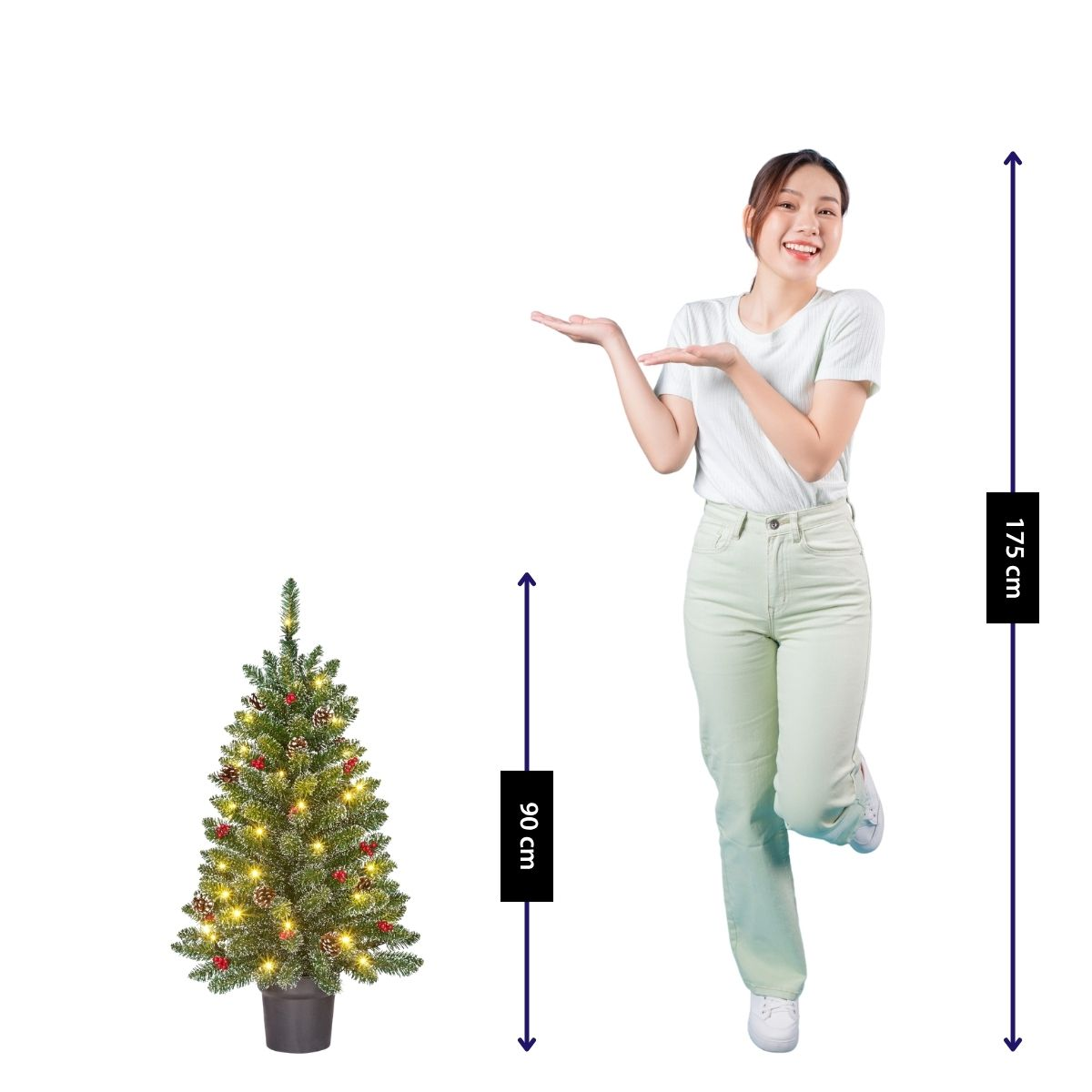 A woman stands next to a decorated Christmas tree. Tree height 90 cm, woman height 175 cm.