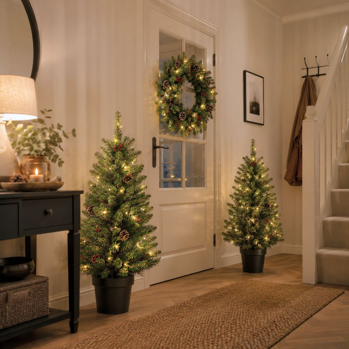 A hallway decorated with Christmas trees, a wreath, and candle light.