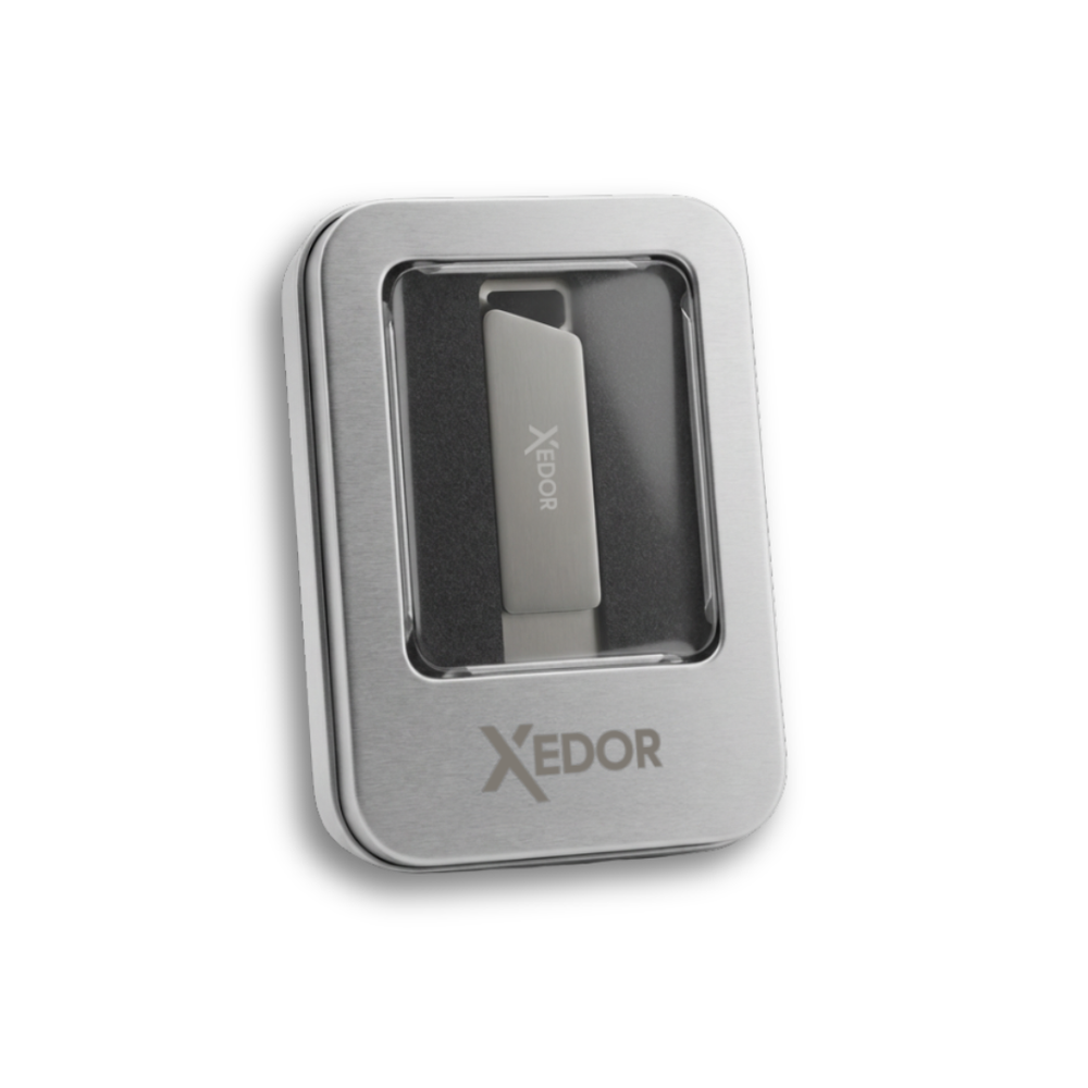 Silver USB drive with Xedor logo in a metal case with a clear window.