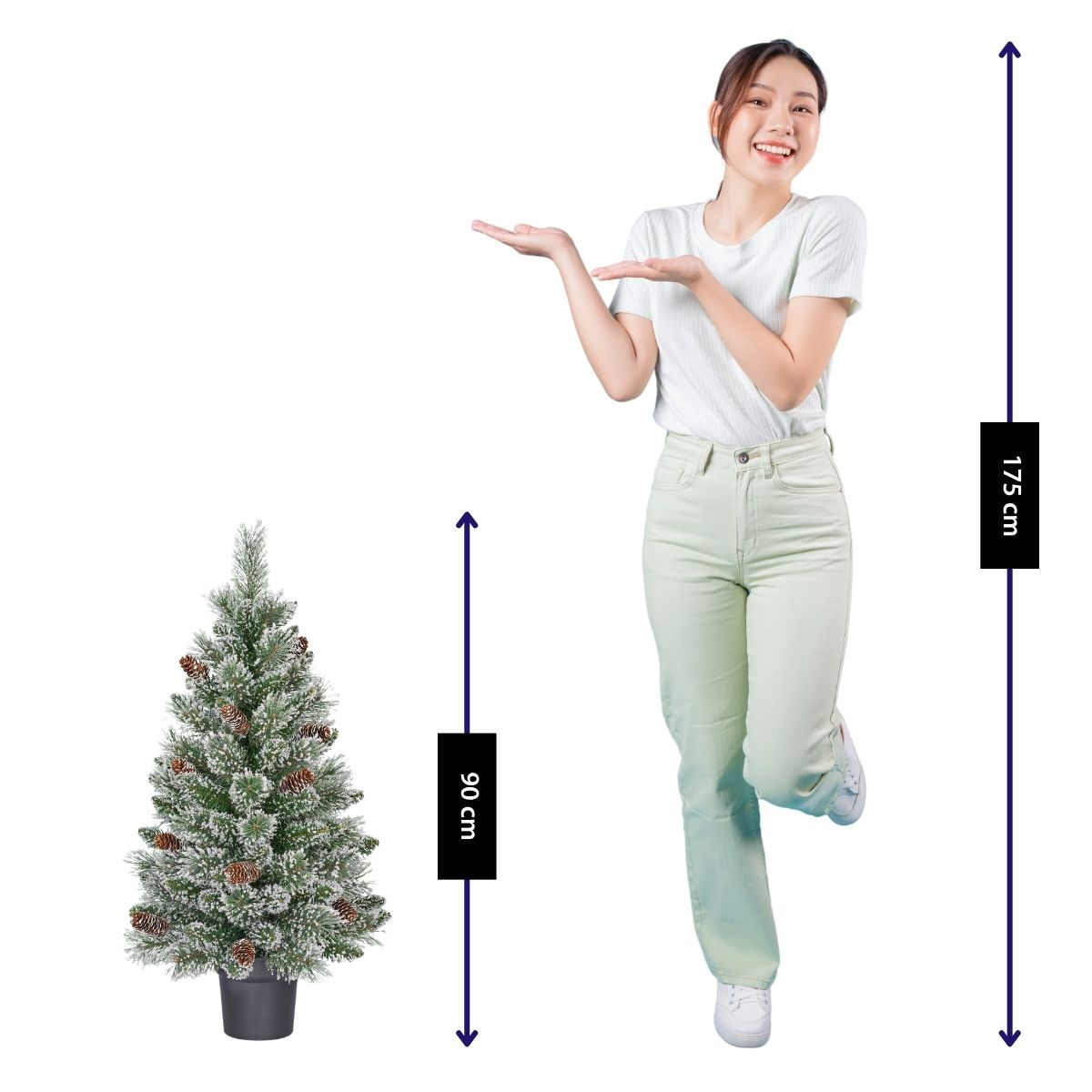A woman stands next to a 90cm Christmas tree with pinecones.