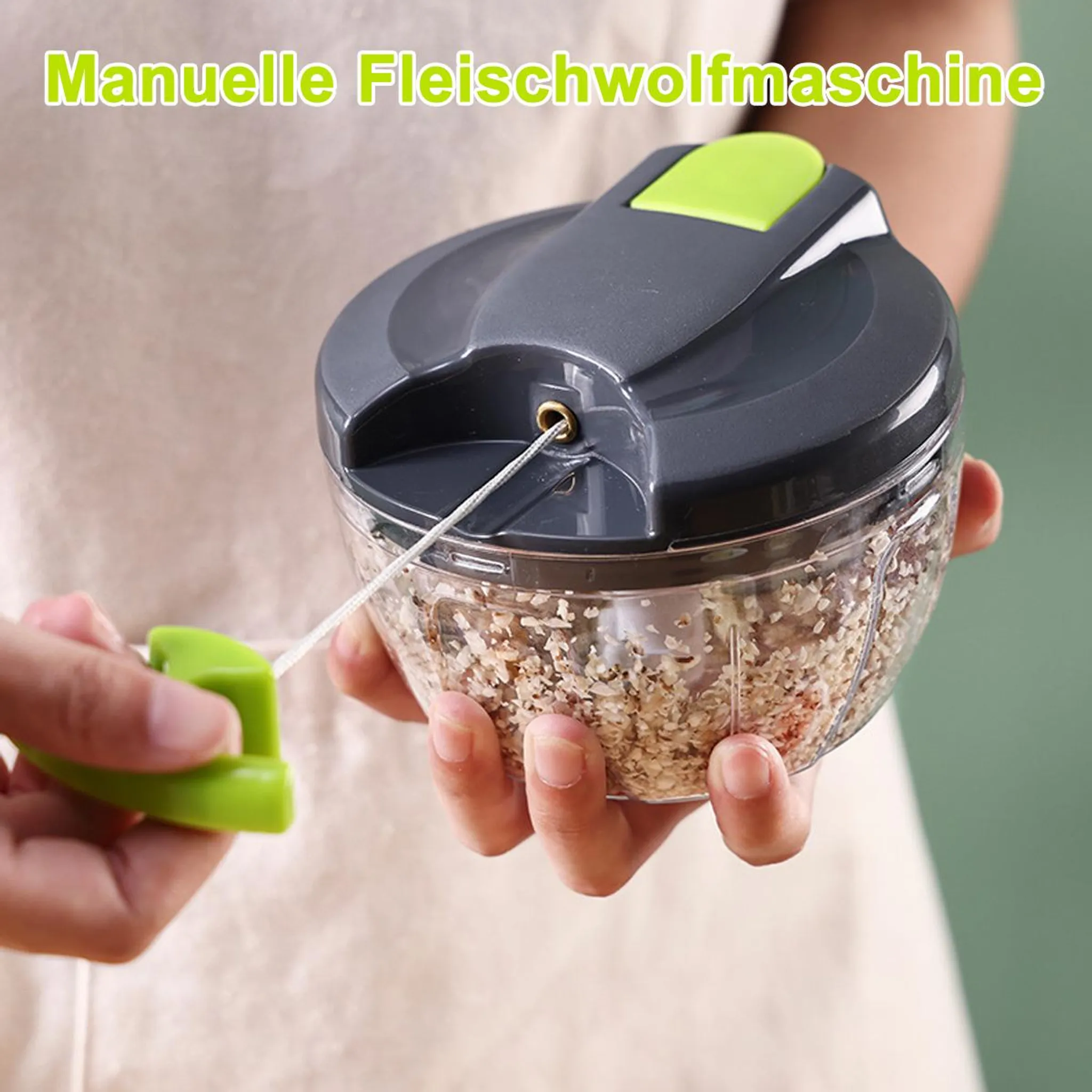 Manuelle Küchenmaschine mit Zugseil, transparentem Behälter und grünem Deckel.