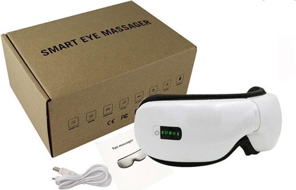 Ein weißes Augenmassagegerät mit Ladekabel und einer Box mit der Aufschrift 'SMART EYE MASSAGER'.
