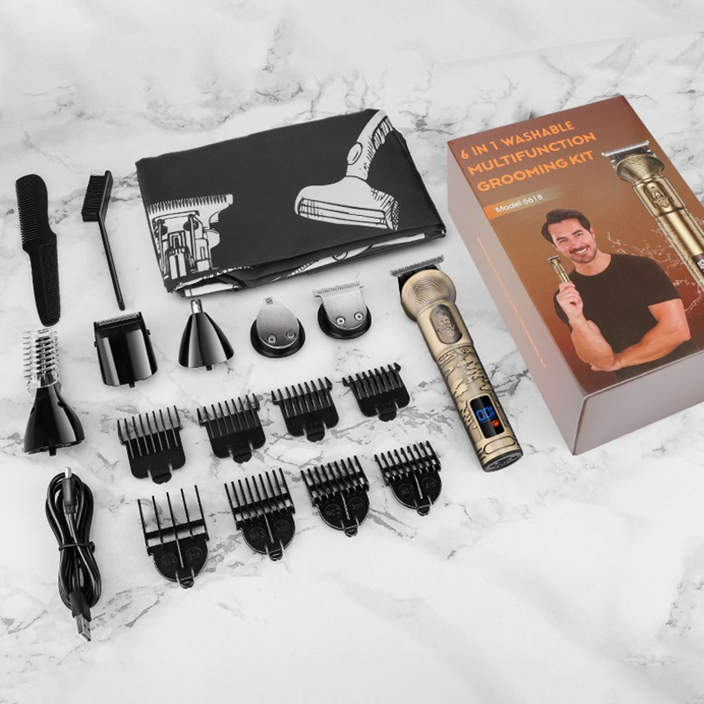 Ein goldener Haarschneider mit Zubehör, darunter Kämme, Klingenkopf und Ladekabel.