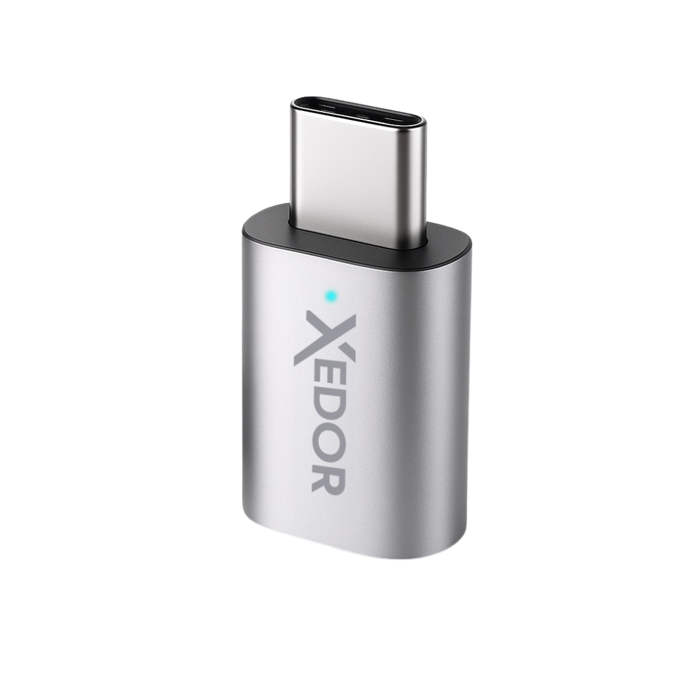 A small silver USB-C adapter with a blue light and the "XEDOR" logo.