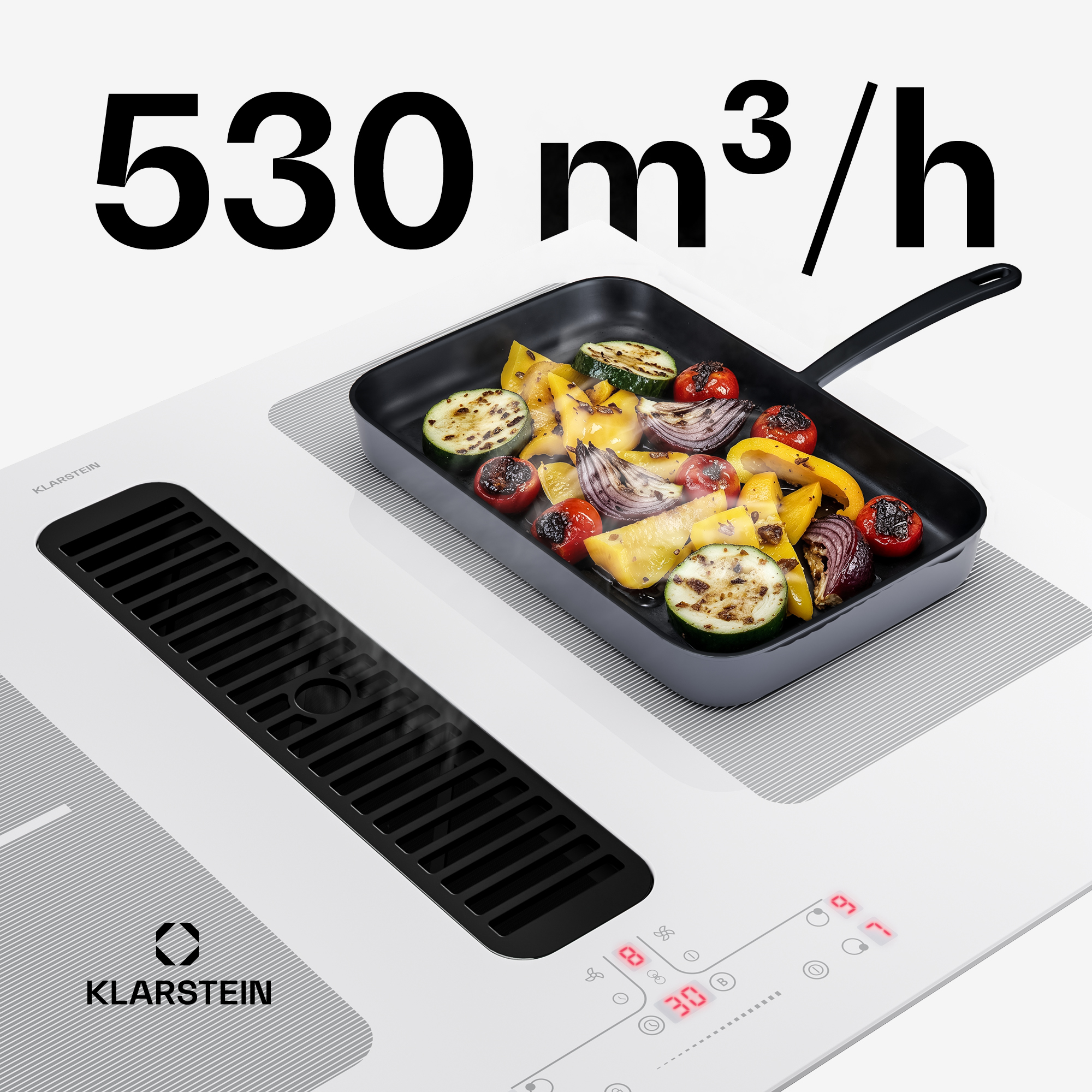 Ein Kochfeld mit Grillgemüse in einer Pfanne und Lüftungsgitter.