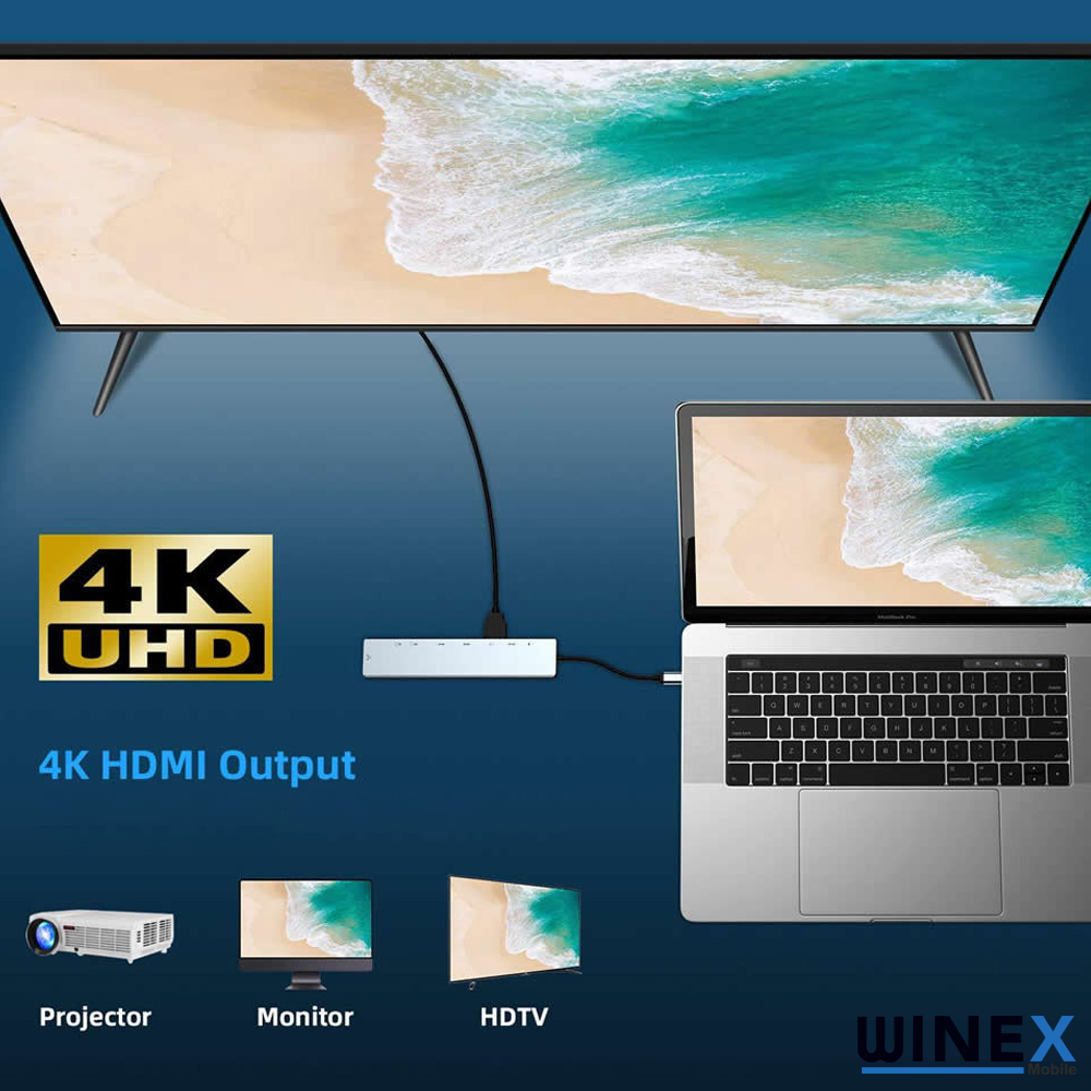 4K UHD hub'a bağlı dizüstü bilgisayar, üç ekranda plaj sahnesi gösteriyor.