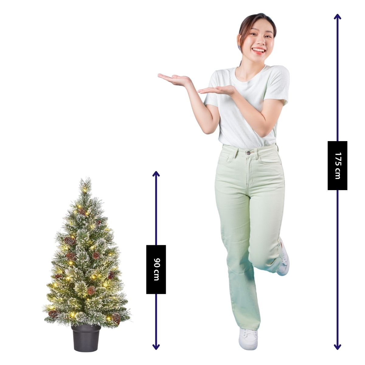 A woman stands next to a decorated 90cm Christmas tree.