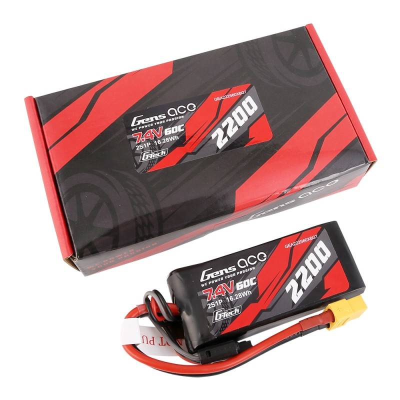 Una scatola rossa e nera con una batteria accanto.